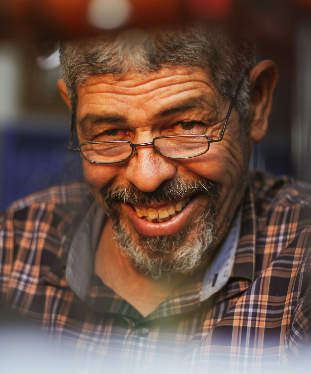 An older man in glasses smiling