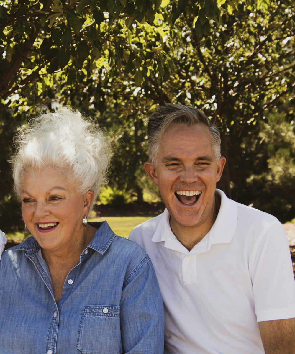 A man laughing with his mother outdoors