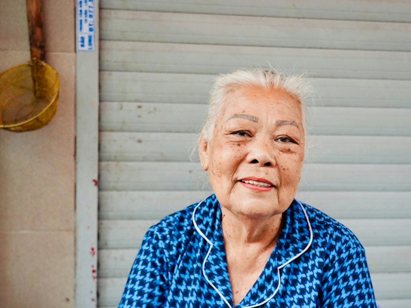 An older woman with white hair smiling